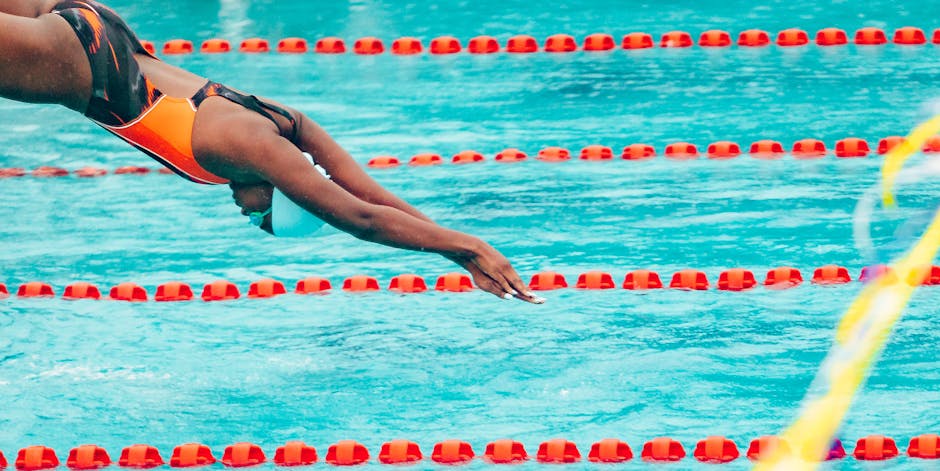 A swimmer takes a powerful dive into a pool during a competitive event in Lagos, Nigeria.