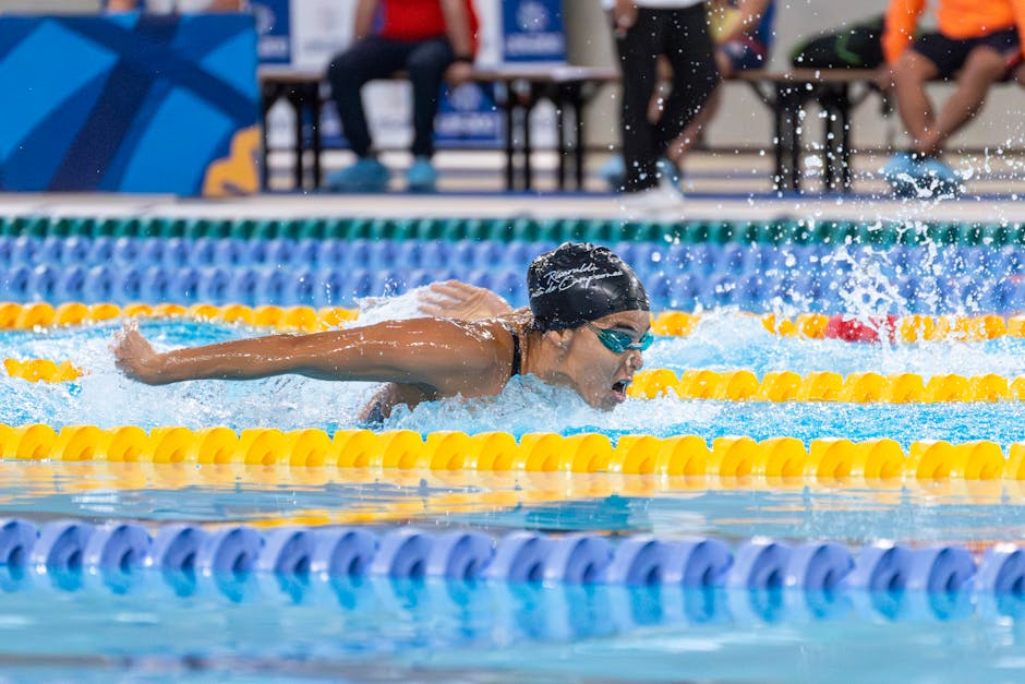 A swimmer in a race swimming the butterfly stroke during a competitive event.