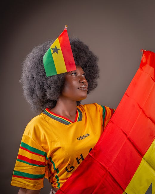 Ghanaian woman with flag and jersey celebrating national pride.