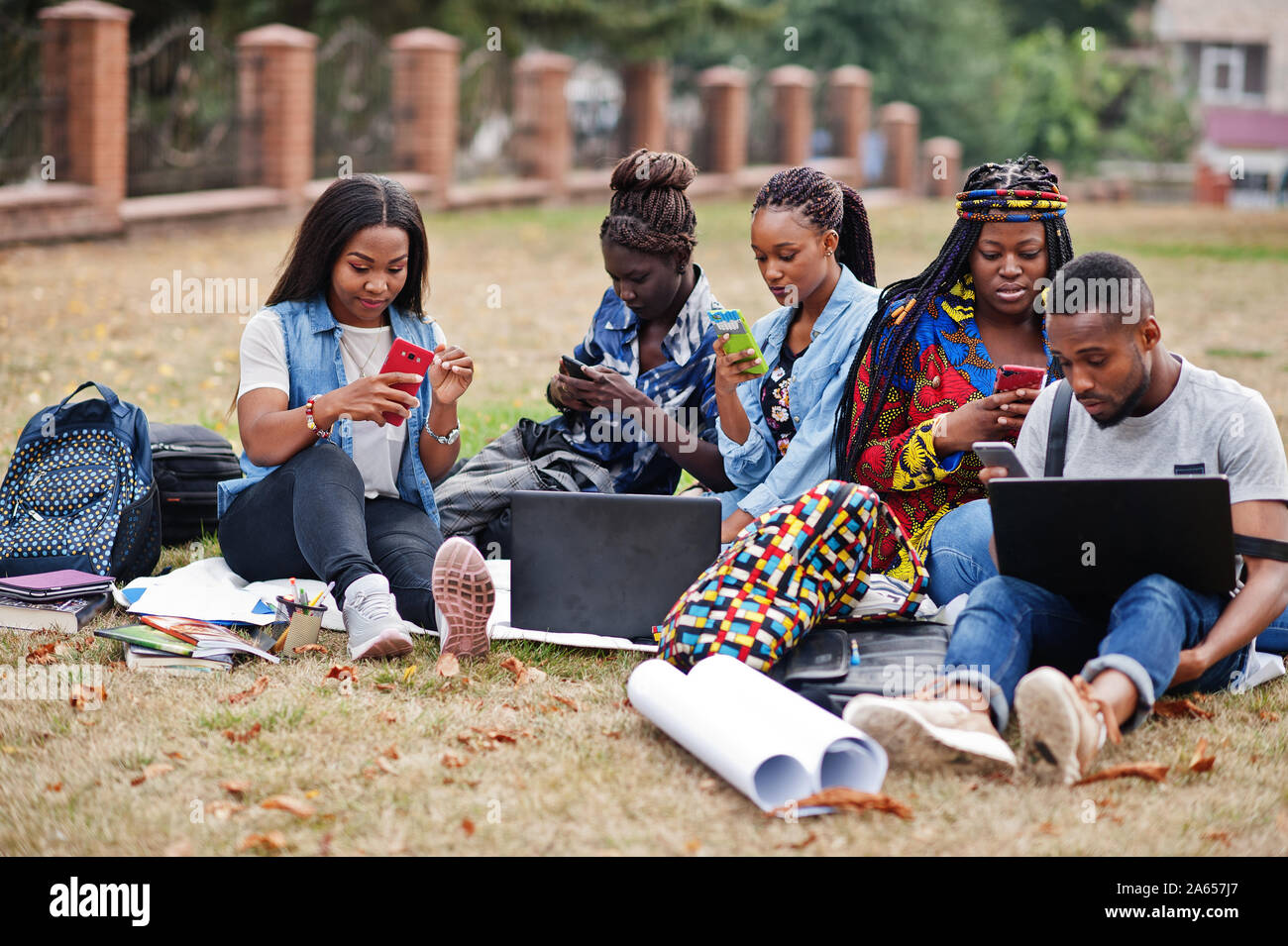 Group of five african college students spending time together on campus at  university yard. Black afro friends making with mobile phones. Education th  Stock Photo - Alamy