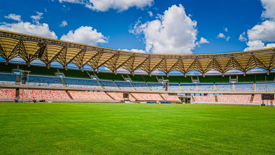 Vibrant view of Benjamin Mkapa National Stadium with clear blue skies in Dar es Salaam, Tanzania.