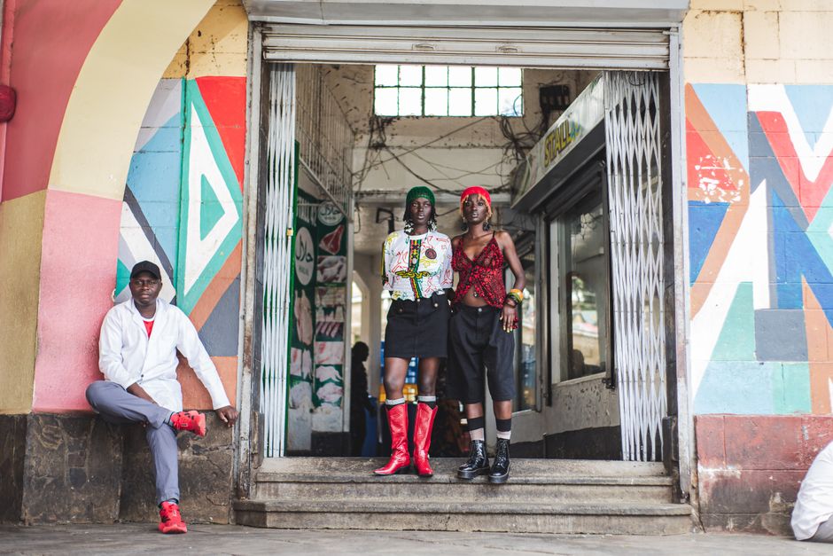 Two fashionable young adults posing in a colorful urban setting in Nairobi, Kenya.